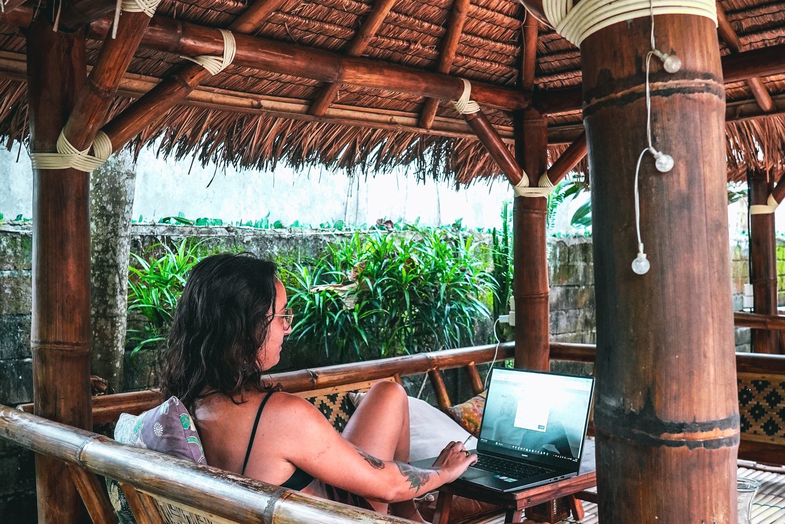 A guest relaxing in a berugak at The Spot